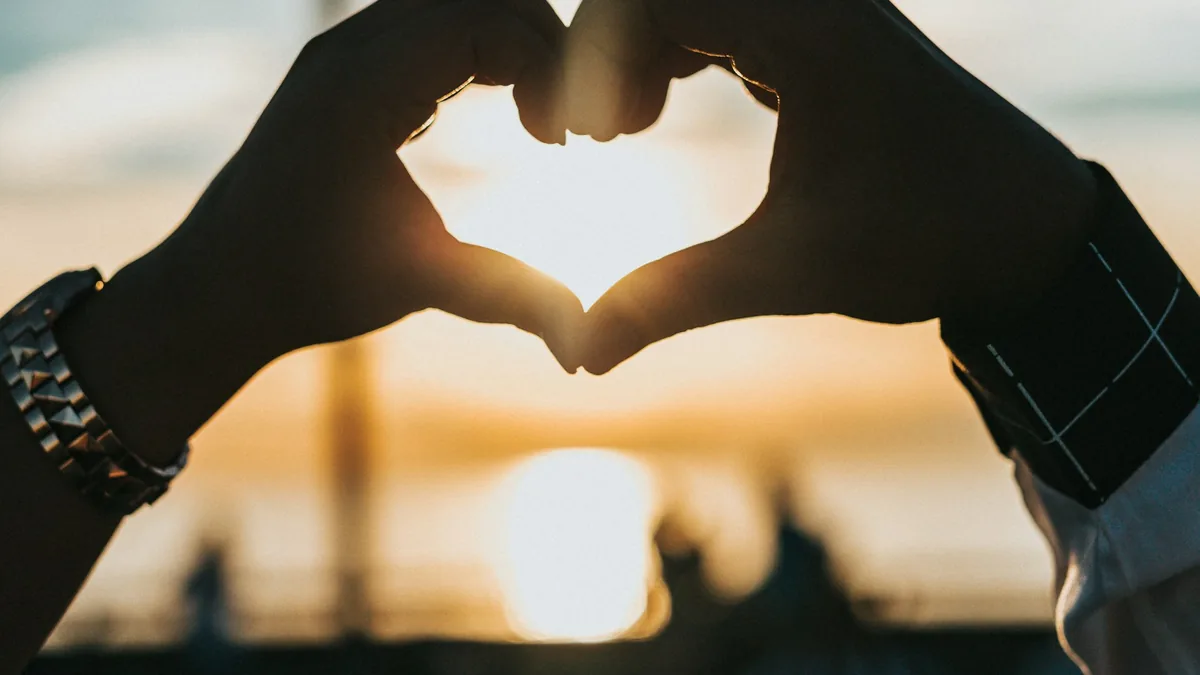 Couple holding hands at sunset representing emotional security, trust, and relationship stability