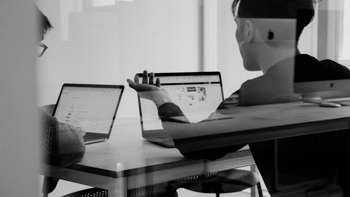 Business leaders and analysts reviewing strategy roadmaps and data analytics with AI guidance