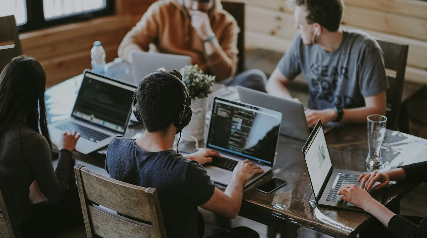 Software engineers and IT systems specialists collaborating on cloud infrastructure, code development, and network workflows